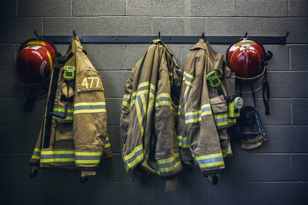 Firefighter turnout jackets hanging in a row