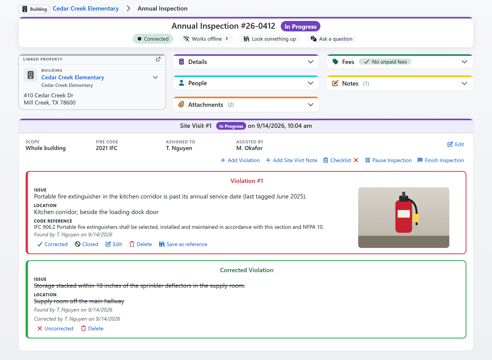 An annual inspection in progress in FireInspection360: the site visit card with two open violations, one with a photo, the checklist button and the Finish Inspection action (sample data)